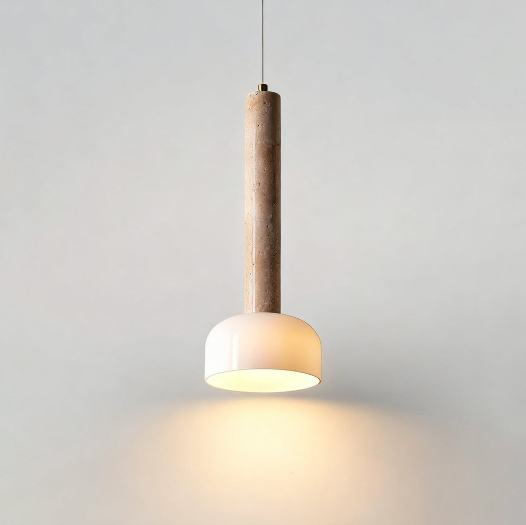 Light pools downward from the white dome of this Clérachic pendant light, hung against a plain pale wall.