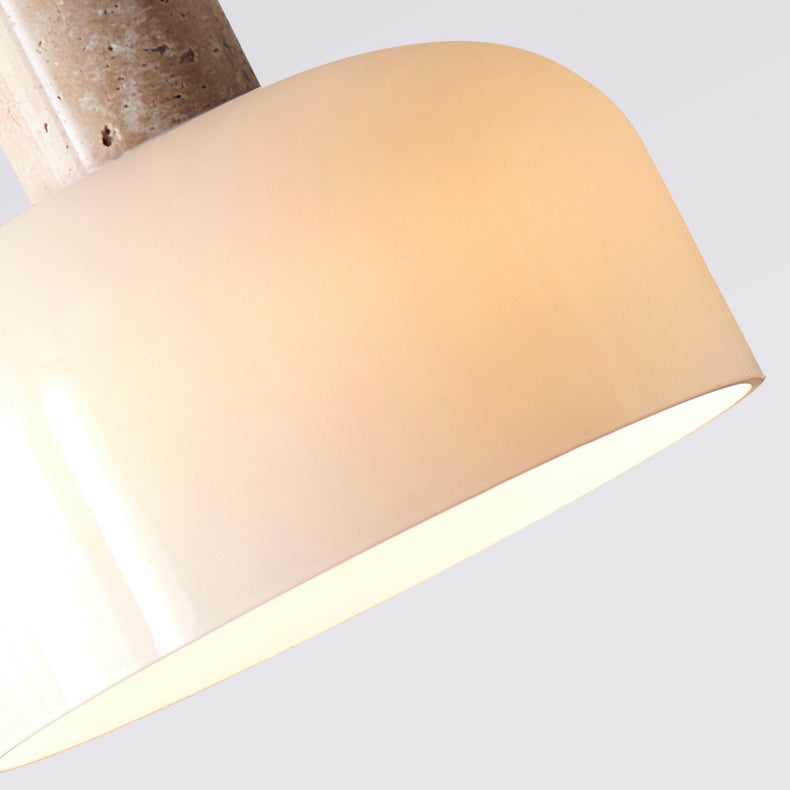 Close view of the glossy white half-dome of this Clérachic pendant light, lit warmly inside beneath the stone stem.