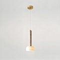 This Clérachic pendant light hangs from a round gold ceiling plate on a fine cord, with the stone stem above a glowing dome.