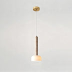 This Clérachic pendant light hangs from a round gold ceiling plate on a fine cord, with the stone stem above a glowing dome.
