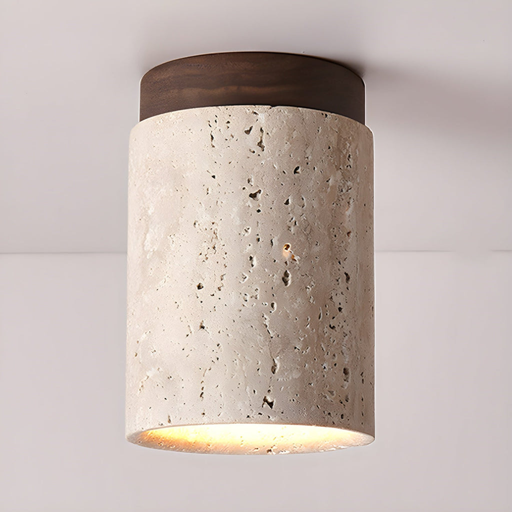 Clérachic ceiling light with a walnut cap, the pale travertine pitted with natural holes and glowing at the lower edge.