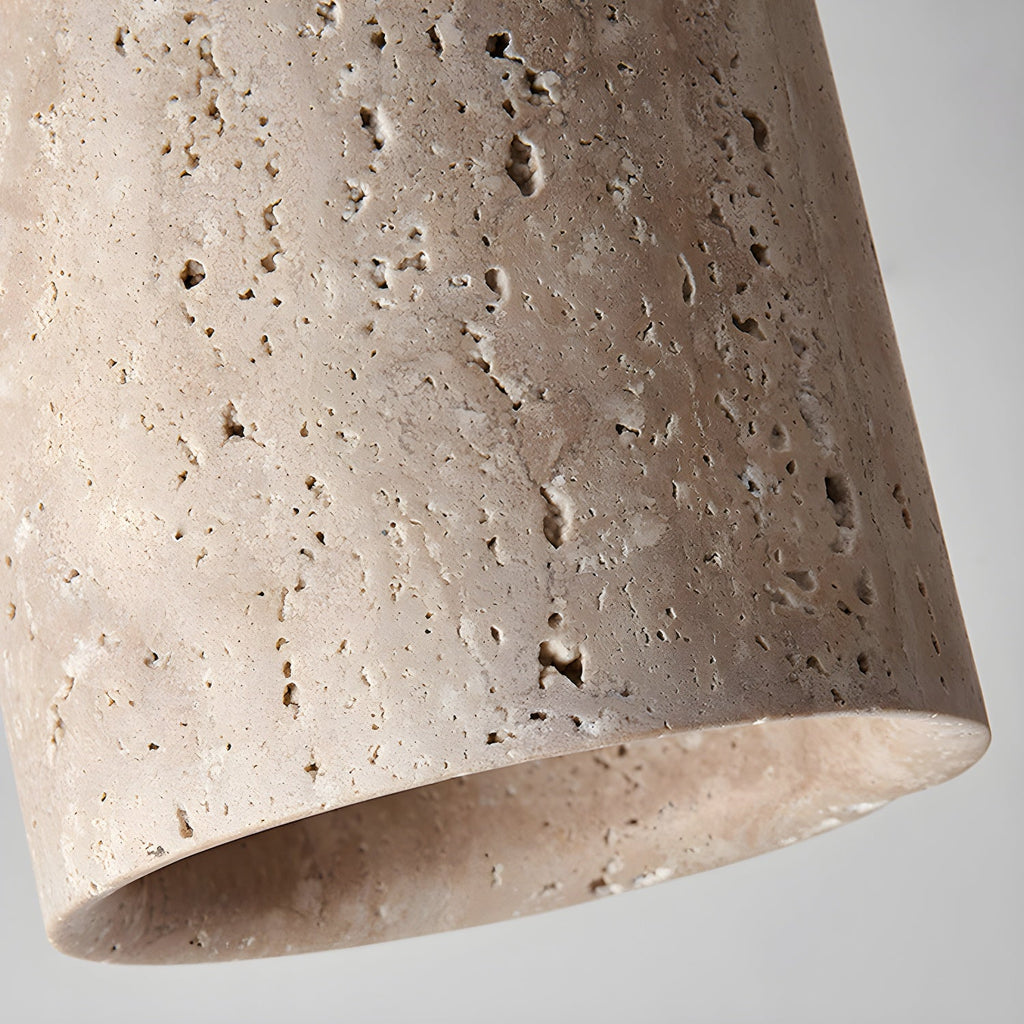 Close view of the pitted travertine surface and thick lower rim of this Clérachic ceiling light.