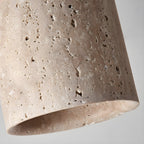 Close view of the pitted travertine surface and thick lower rim of this Clérachic ceiling light.
