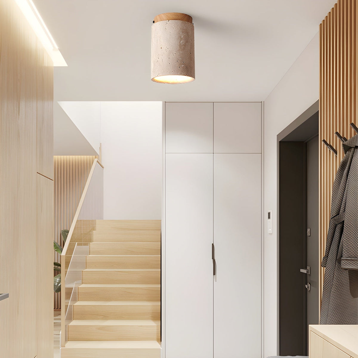 Clérachic ceiling light with a wood-colour cap lit in an entry hall beside a pale wood staircase and white cabinets.