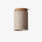 Side view of this Clérachic travertine ceiling light with its wood-colour cap, shown on a plain light backdrop.