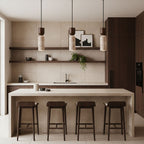 Three small Clérachic travertine pendants in a beige kitchen with dark wood cabinets, shelves and a long island with four stools.