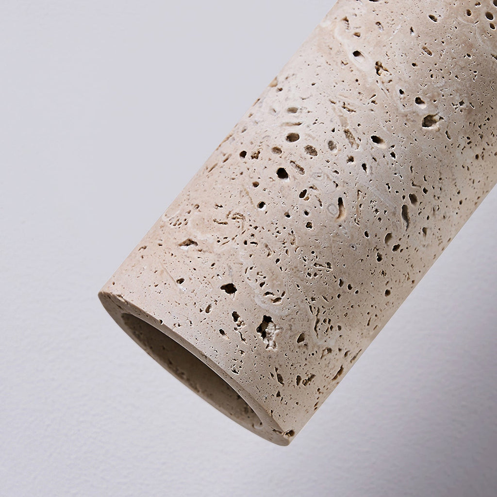 Close view of the pitted travertine surface and open end of this Clérachic pendant cylinder.