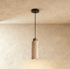 Clérachic's round travertine drum pendant hangs on a slender black cord, its dark wood cap topping the stone cylinder.