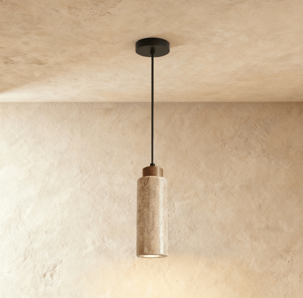 Clérachic's round travertine drum pendant hangs on a slender black cord, its dark wood cap topping the stone cylinder.
