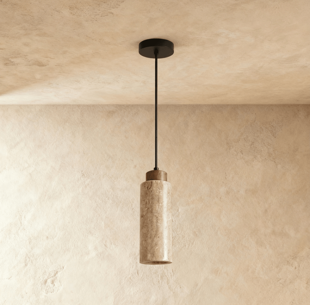A round travertine pendant by Clérachic glows softly from below, its wood cap and stone cylinder catching warm light.
