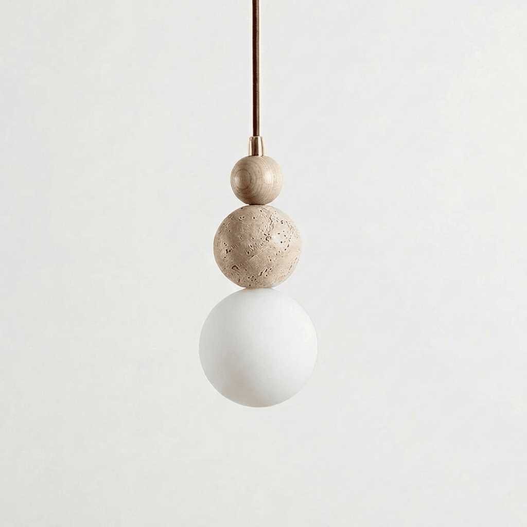 A Clérachic pendant with a travertine top bead and a copper-toned cord fitting above a travertine ball and a white globe.