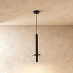 This Clérachic pendant light drops a textured stone-finish cylinder and steel spotlight cap from the ceiling.