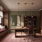 This Clérachic pendant light hangs in a trio above a walnut desk in a moss-green study with a pink rug.