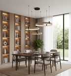 Above a dark wood dining table with grey chairs, a Clérachic cluster of three travertine rings hangs in front of backlit shelves.