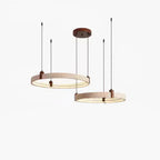 Two travertine rings at different heights, from a Clérachic pendant, with a warm strip of light inside each ring and a white backdrop.