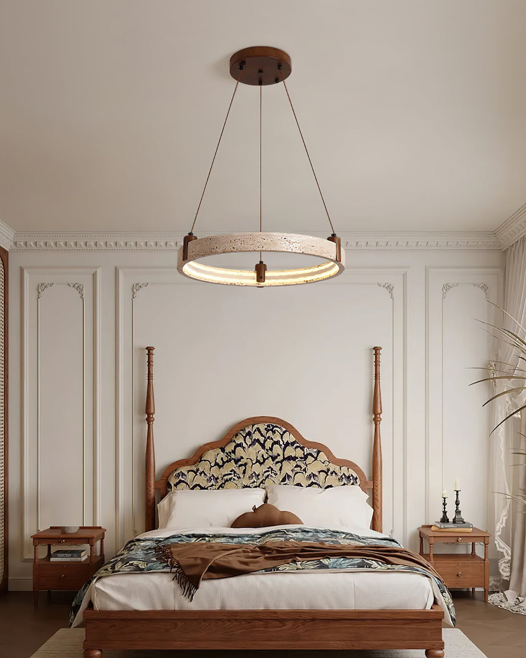 A Clérachic ring pendant hangs in a bedroom with a carved wooden four-poster bed, bedside tables and panelled walls.
