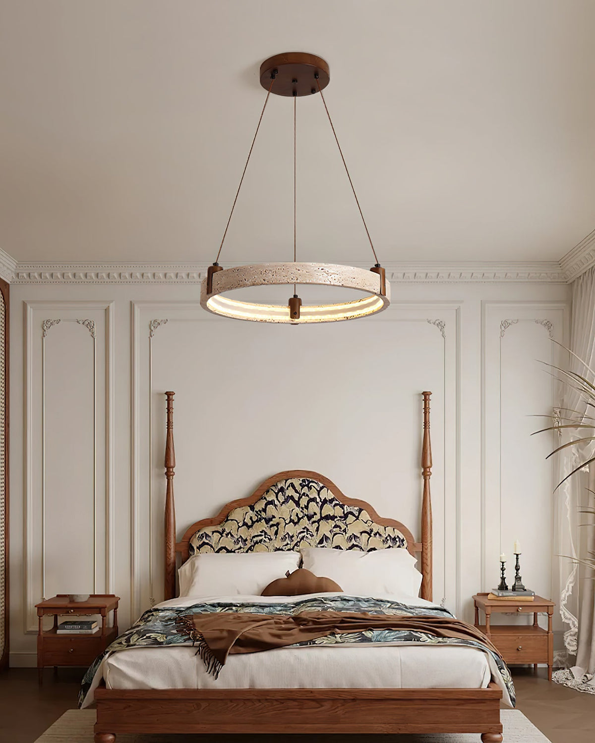 A Clérachic ring pendant hangs in a bedroom with a carved wooden four-poster bed, bedside tables and panelled walls.