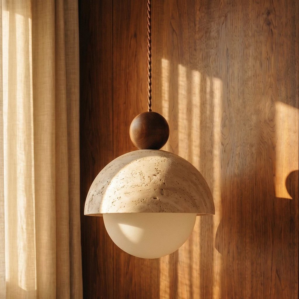 Close-up of the Clérachic pendant light's walnut ball finial and stone dome against wood panelling.