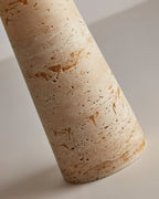 Close view of the pitted, honey-veined travertine on the base of this Clérachic table lamp.