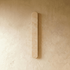 Clérachic slim cream travertine wall light with rounded ends, switched off and mounted on a warm limewashed wall.