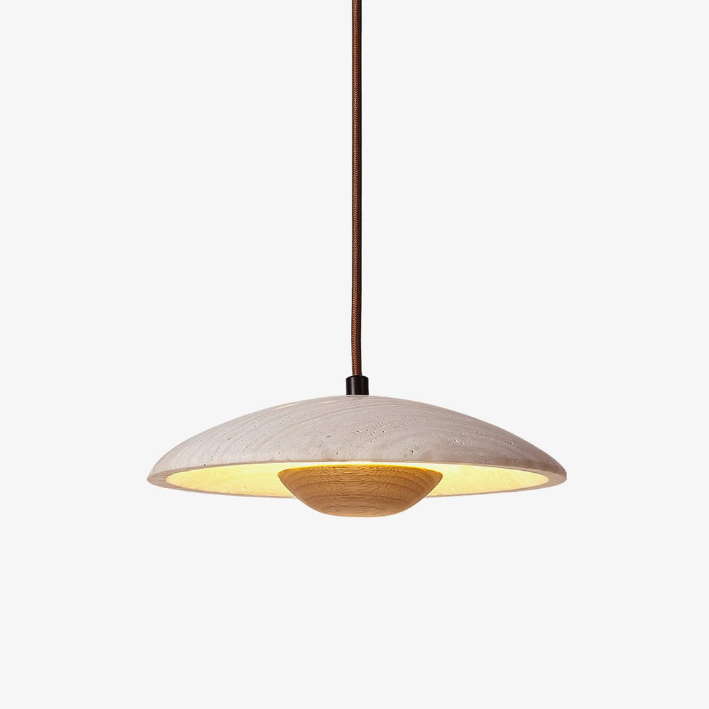 Clérachic travertine pendant with a wood bowl underneath and a brown fabric cord, lit warm on a plain white backdrop.