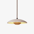 Clérachic travertine pendant with a wood bowl underneath and a brown fabric cord, lit warm on a plain white backdrop.