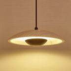 Underside view of this Clérachic pendant glowing warm, the stone shade rim lit and a walnut-toned bowl at the centre.