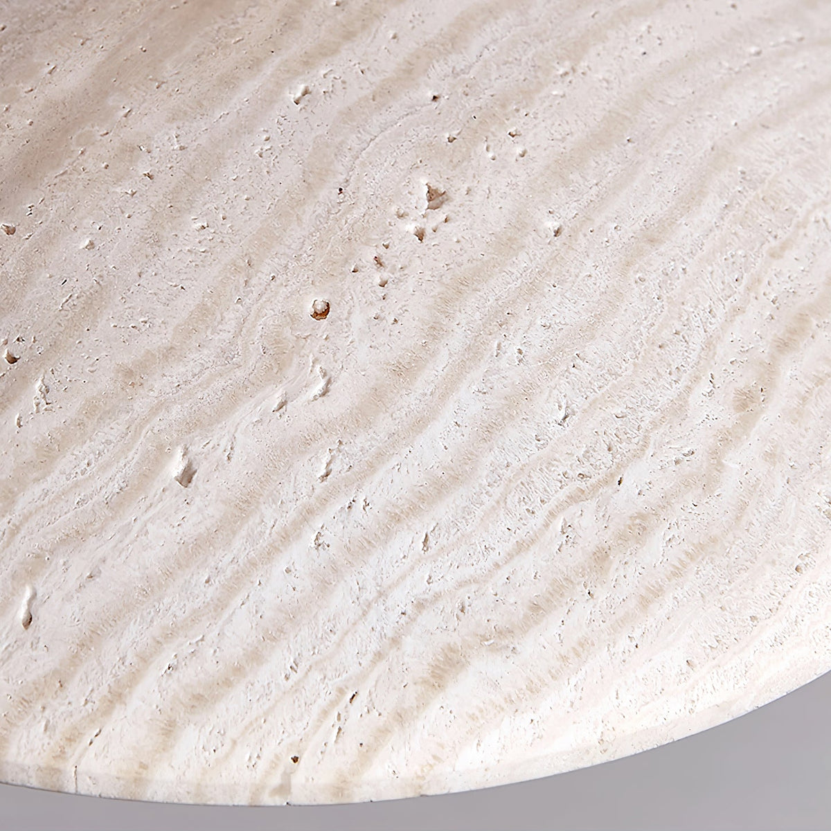 Close view of the pitted, banded travertine surface on this Clérachic pendant's shade.