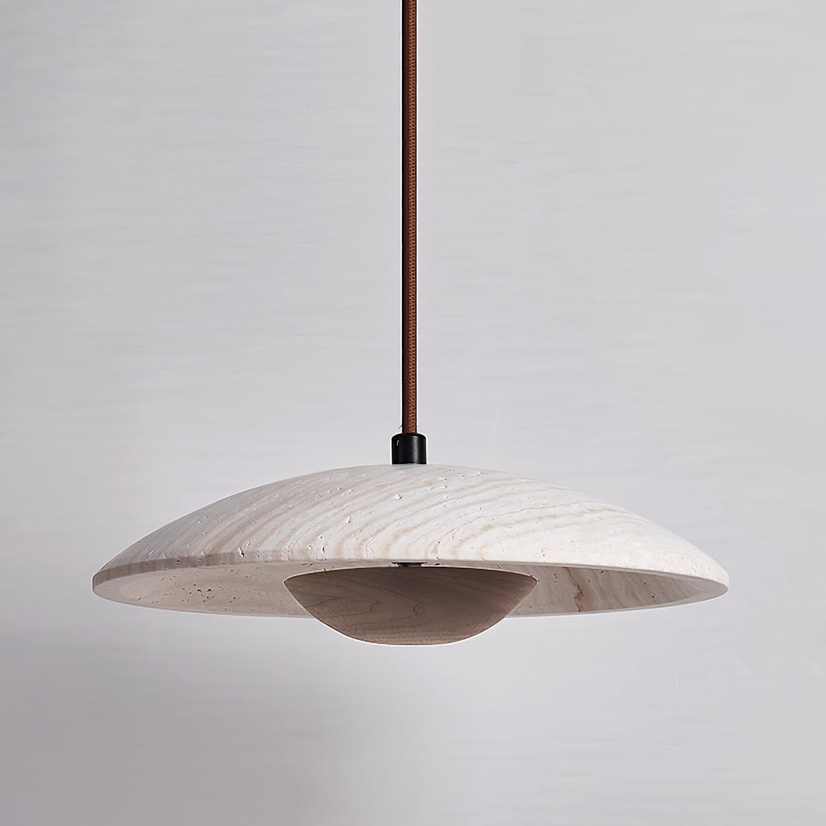 Clérachic pendant with a veined stone shade and a dark walnut-toned bowl, shown against a cool grey backdrop.
