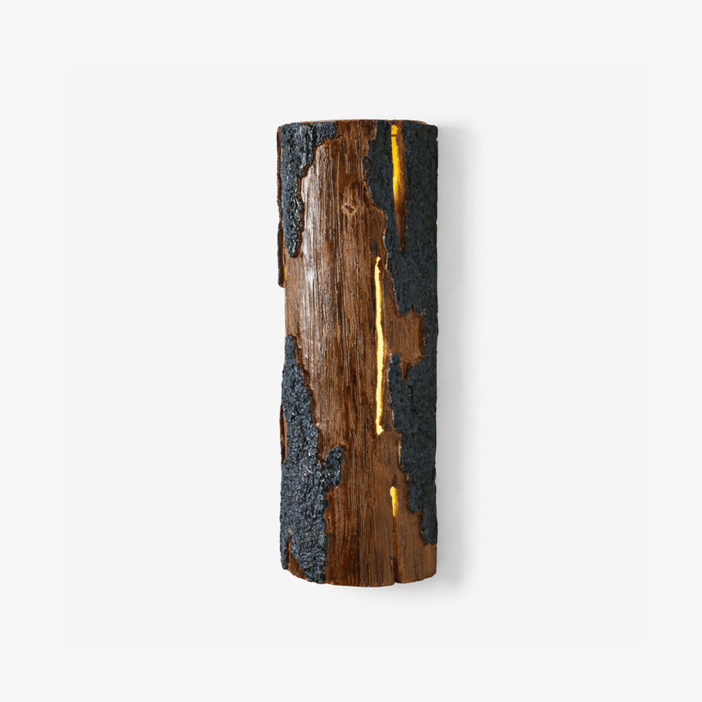 Tall half-round Clérachic wall light in the Bark finish, with a warm glow showing through a slit in its brown and blue-grey textured surface.