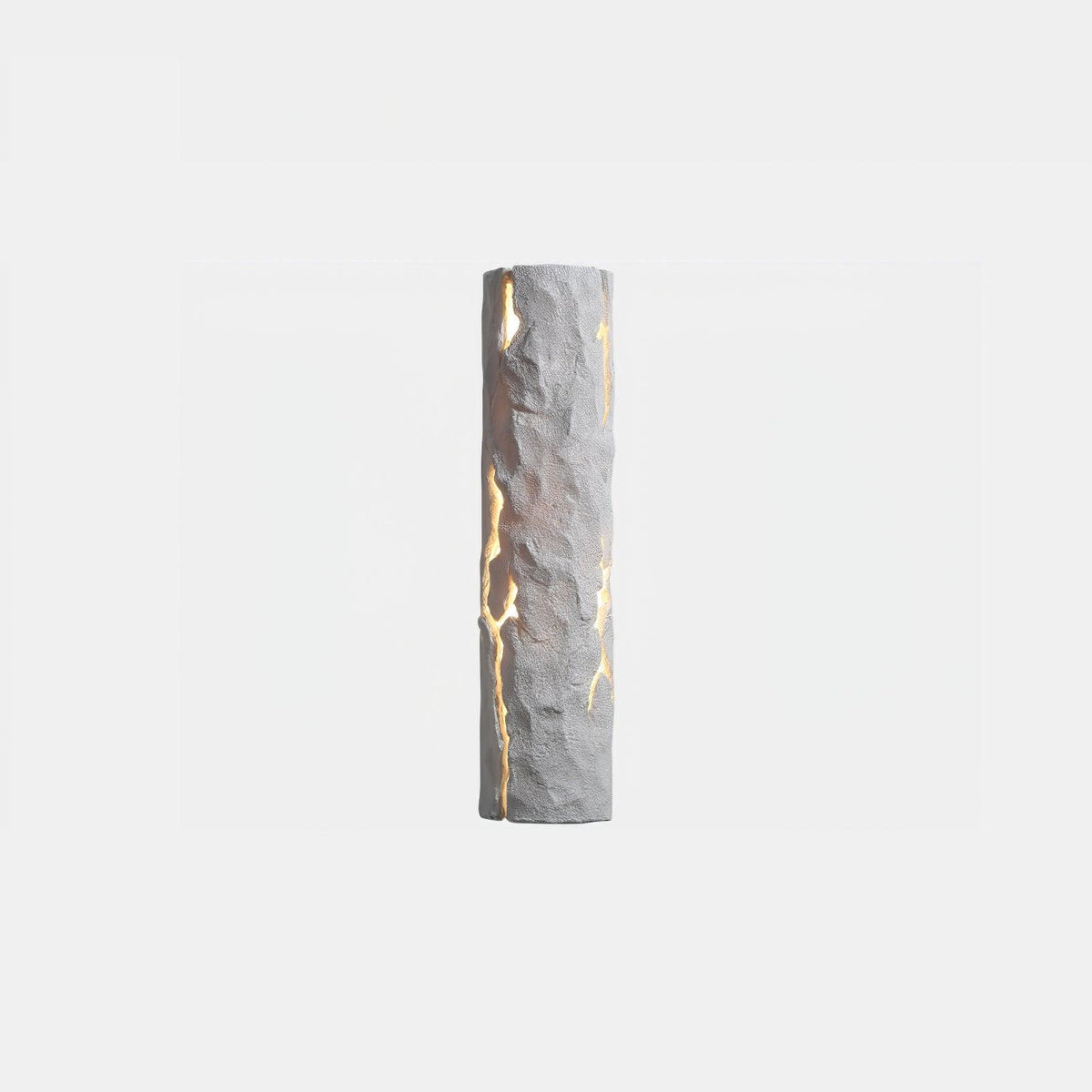 A white Clérachic wall light with a chiselled, cracked surface and light shining through the fissures, on a pale backdrop.