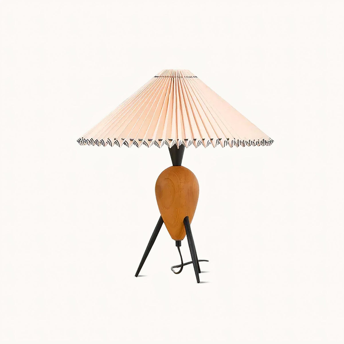 A Clérachic table lamp on a plain off-white backdrop, with its beige pleated shade and wood base in clear, even light.