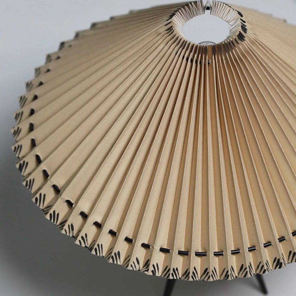 Looking up into this Clérachic table lamp's shade, the pleats fan out from the centre ring to a stitched edge.