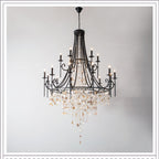 Clérachic Trove in black at a larger size, a tall tapered body opening into two lit tiers of candle arms.
