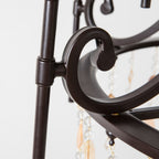 Detail of the Clérachic Trove in black, showing the scrolled joint where a curved arm meets the frame.