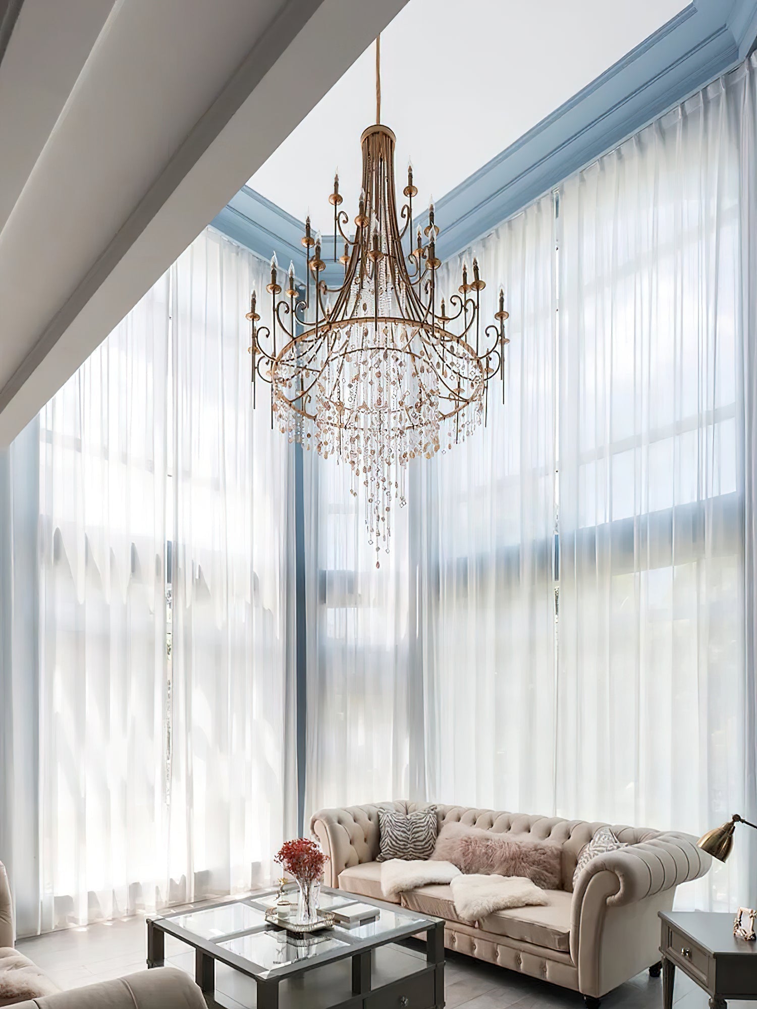 The Clérachic Trove in brass suspended in a sunlit window bay, crystal drops catching the daylight.