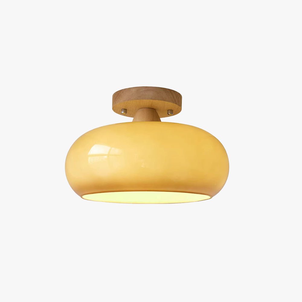 Studio view of the Clérachic turned wood ceiling light, its glossy mustard glass dome seated under a natural wood canopy.