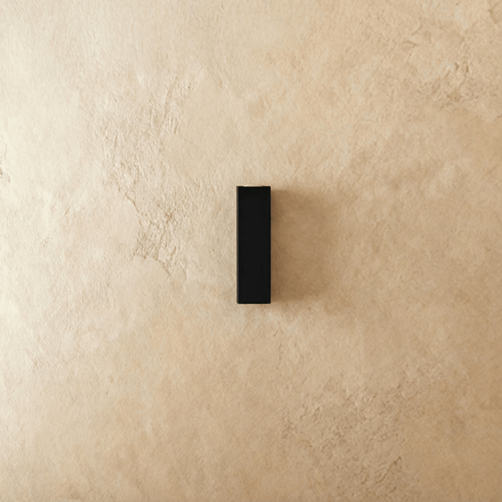 Unlit, this Clérachic outdoor wall light shows its slim black aluminium block ready to mount on an exterior wall.