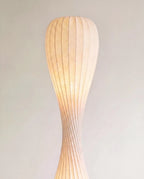 Clérachic close-up of the lit upper shade, showing fine vertical ribs and a soft glowing paper-like texture.