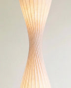 Clérachic close-up of the twisted waist of the shade, where the ribs spiral and the warm light glows through.