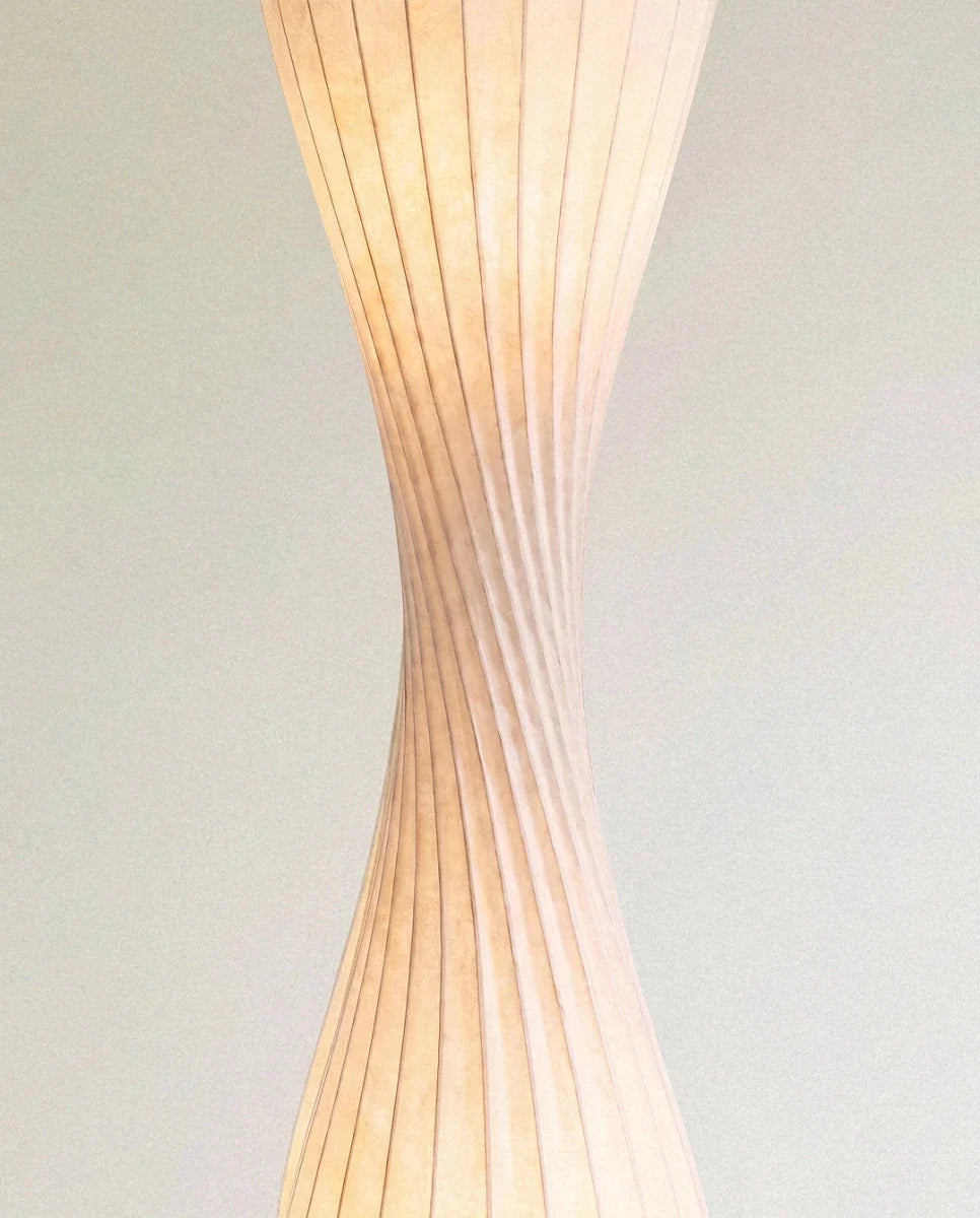 Clérachic close-up of the twisted waist of the shade, where the ribs spiral and the warm light glows through.