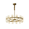 Clérachic Two-Ring Chandelier on white, its alabaster cylinders ringed in brass beneath a velvet-wrapped rod.