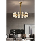 The Clérachic Two-Ring Chandelier hung over a neutral living room, unlit shades reading milky against a taupe wall.