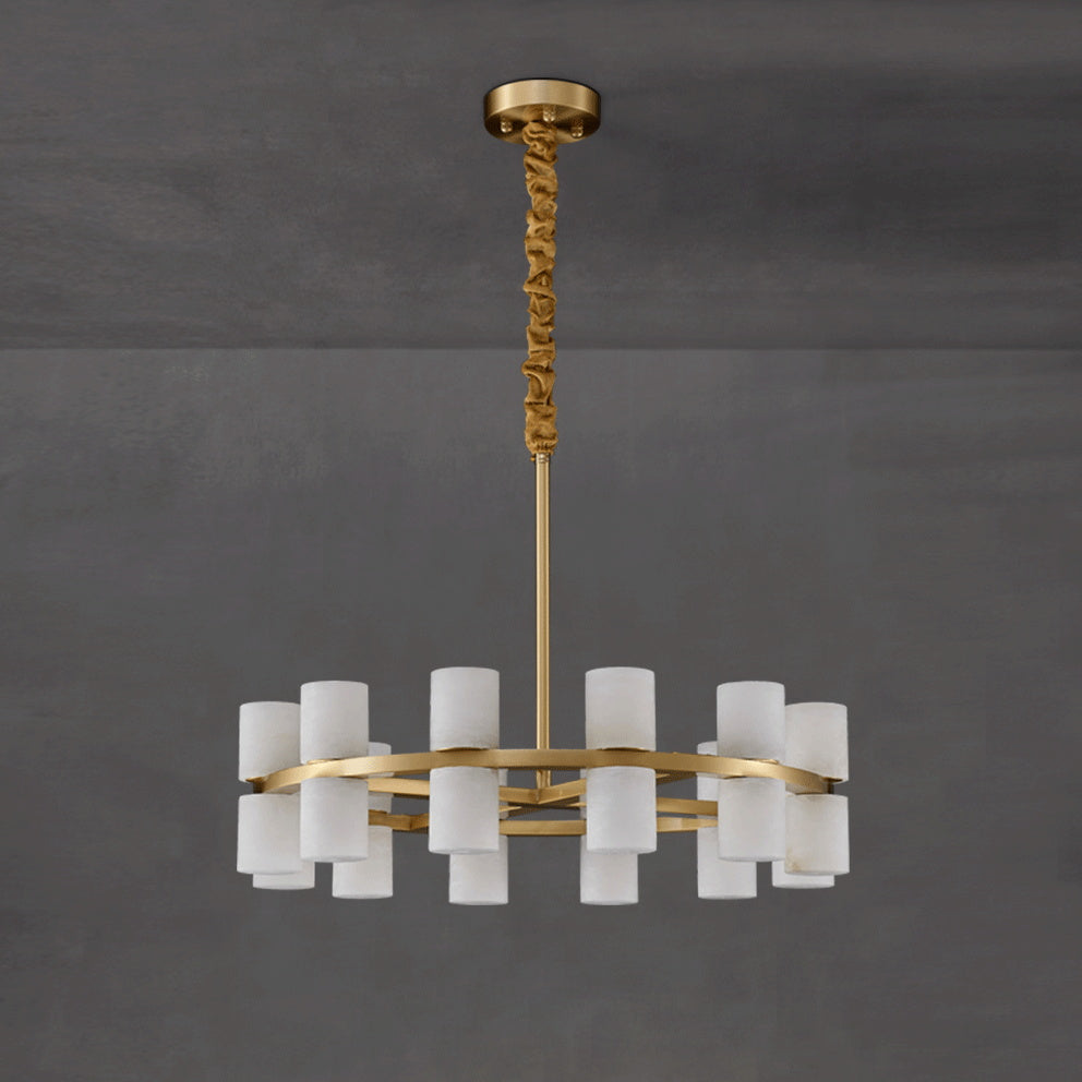 Clérachic Two-Ring Chandelier against grey concrete, the ochre velvet sleeve gathered along the upper brass rod.