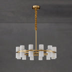 Clérachic Two-Ring Chandelier against grey concrete, the ochre velvet sleeve gathered along the upper brass rod.