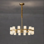 Clérachic Two-Ring Chandelier viewed from the side on a grey wall, the two brass rings staggering shades up and down.