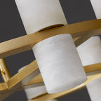 Close-up of a single alabaster shade on the Clérachic chandelier's brass ring, one facing up and one facing down.