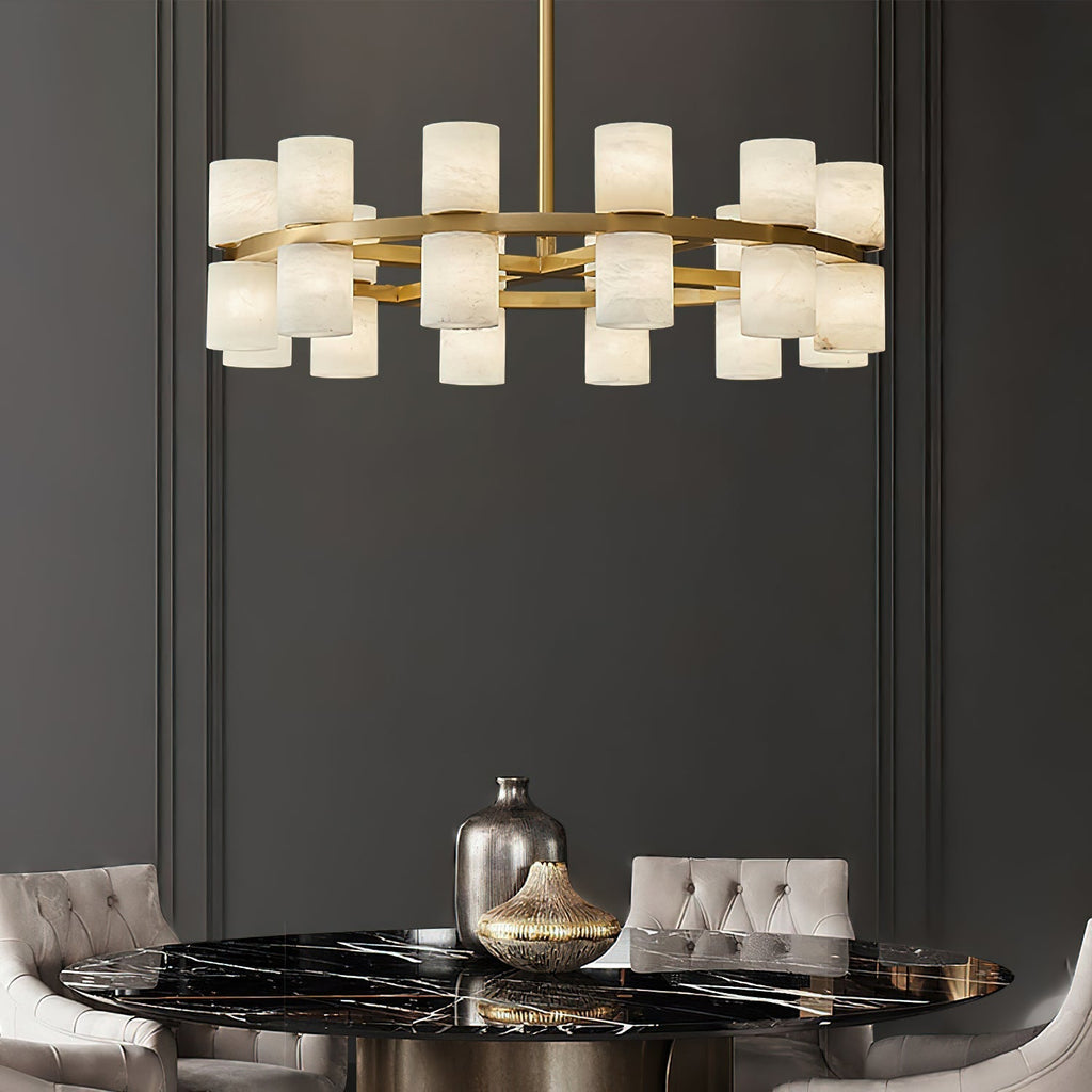 Clérachic Two-Ring Chandelier hanging over a black marble dining table framed by pale velvet chairs.