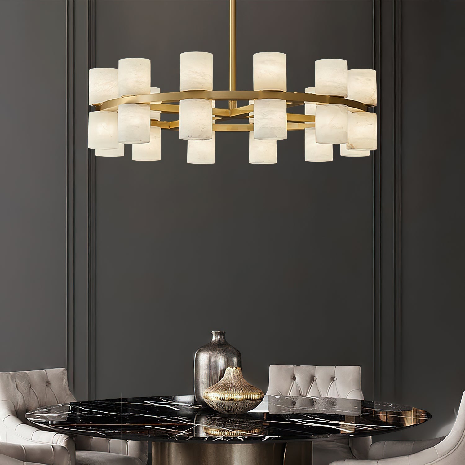 Clérachic Two-Ring Chandelier hanging over a black marble dining table framed by pale velvet chairs.