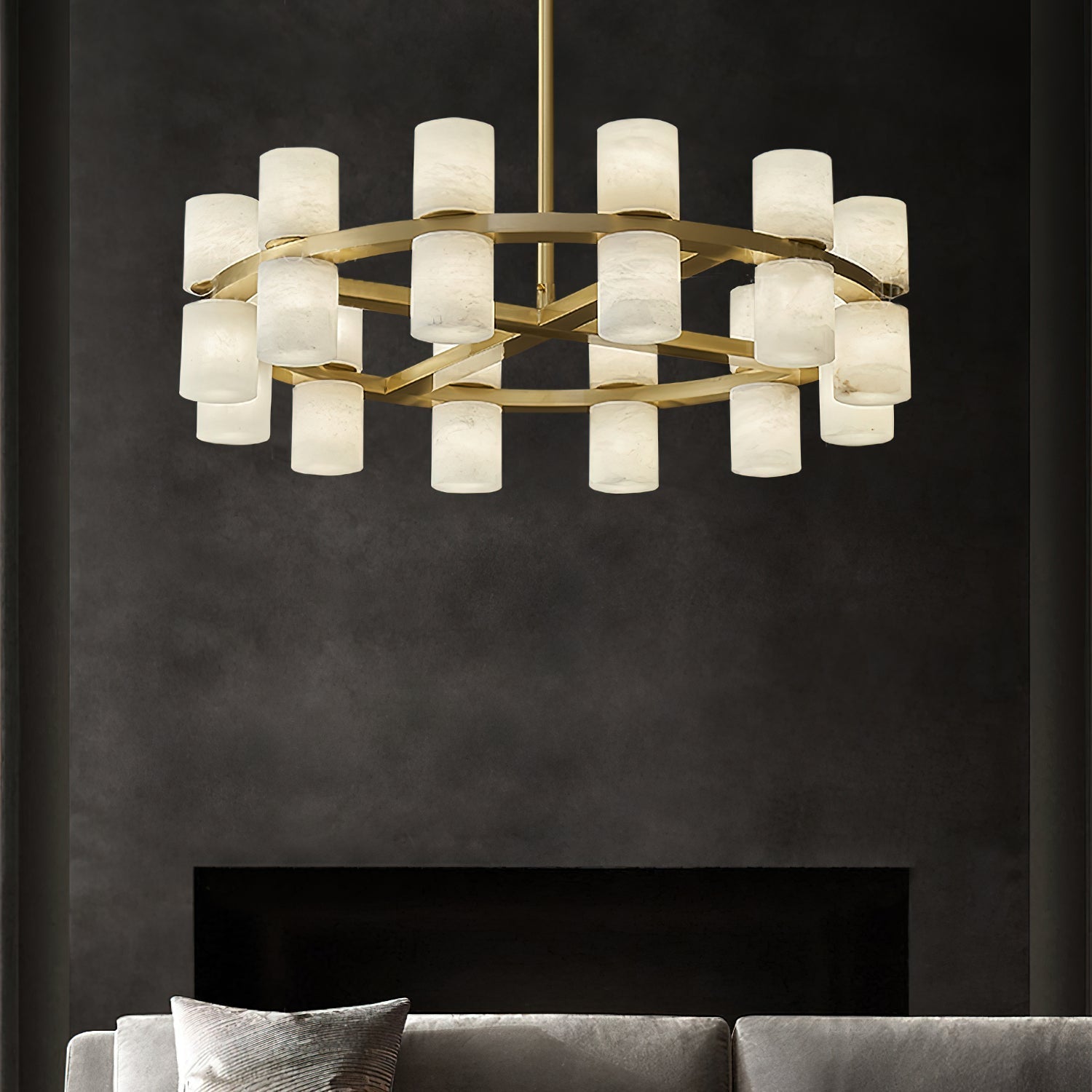 The Clérachic Two-Ring Chandelier above a fireplace wall in charcoal plaster, its alabaster shades glowing warm.